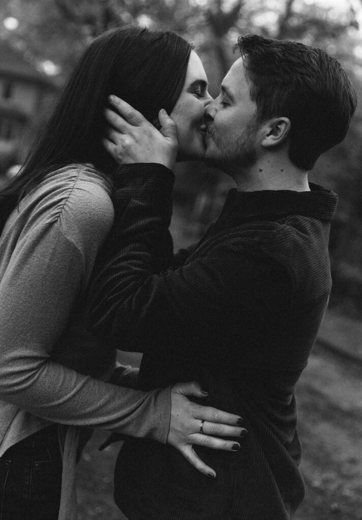 Couple sharing a kiss on a city street during a Virginia Highlands engagement session