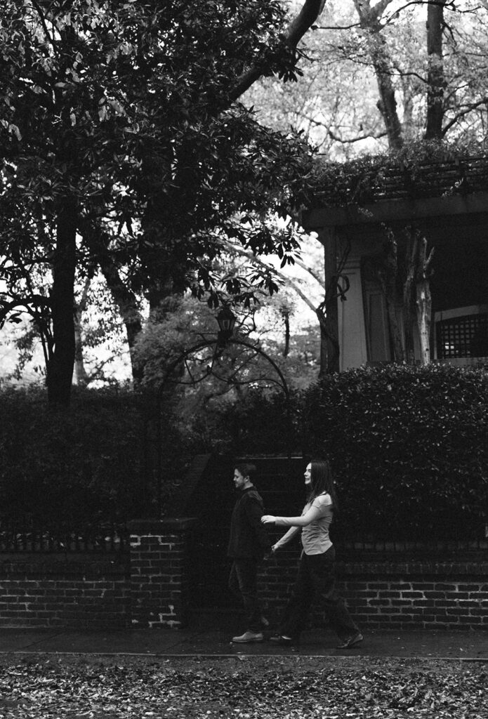 Peyton and Collin walking along the streets of Virginia Highlands in winter