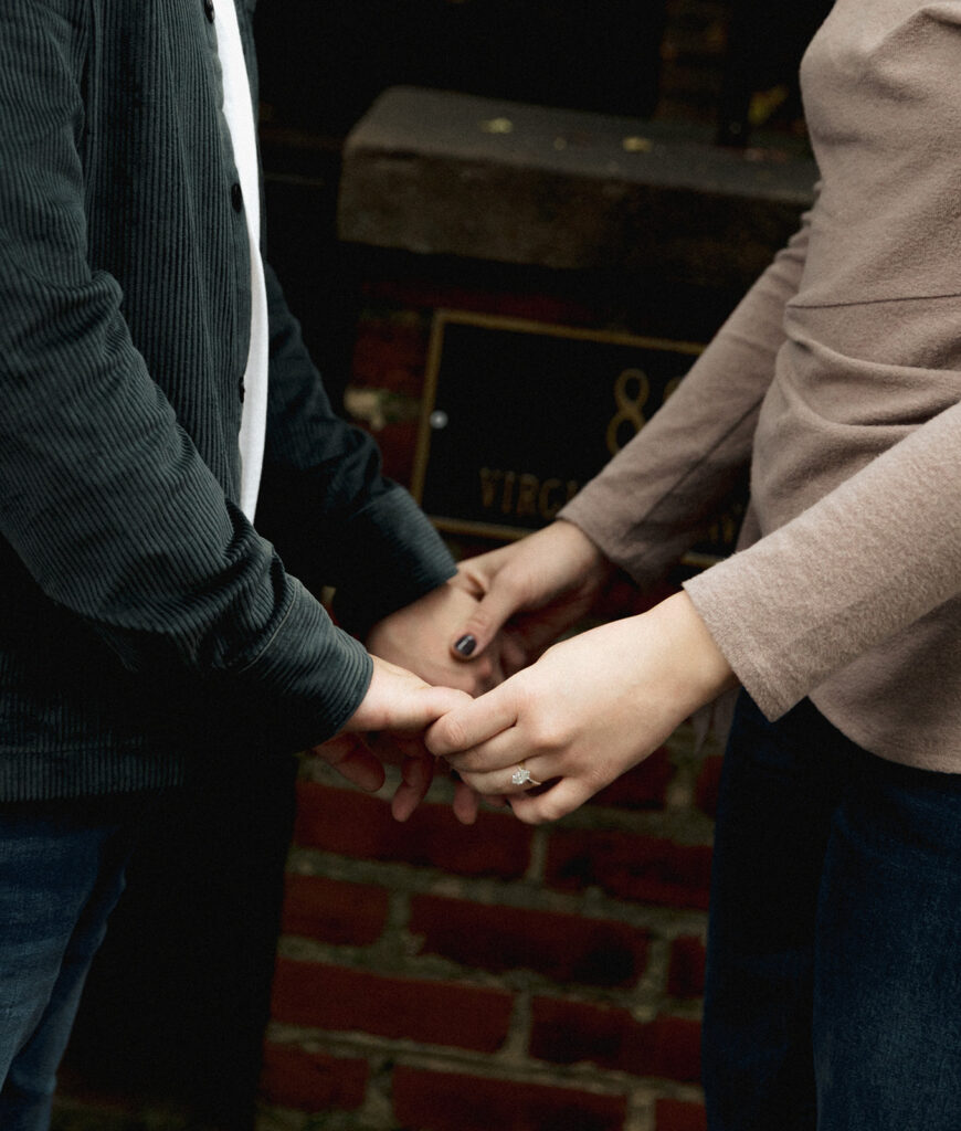 Couple holding hands on a brick street in Virginia Highlands, Atlanta