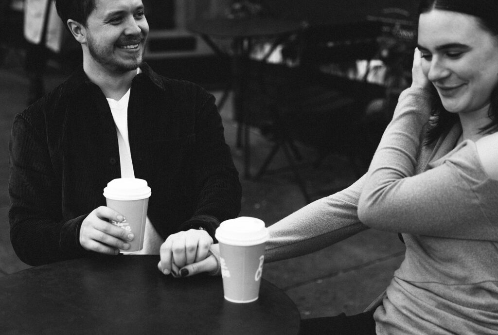 Candid moment of the couple sipping coffee during a Virginia Highlands engagement shoot