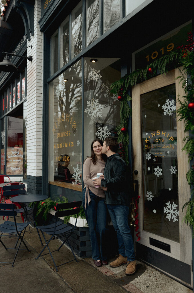 Engagement portraits with holiday lights and brick buildings in Virginia Highlands, Atlanta