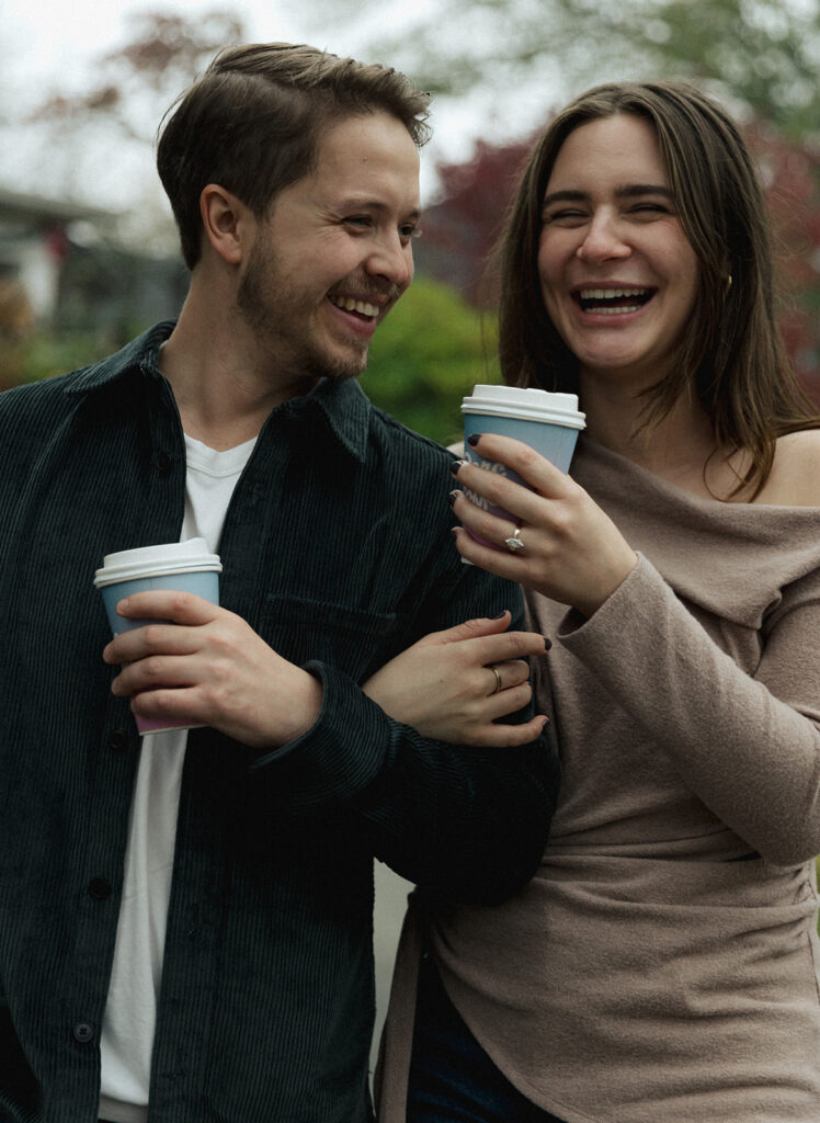 Peyton and Collin sharing a laugh while holding coffee cups in Virginia Highlands