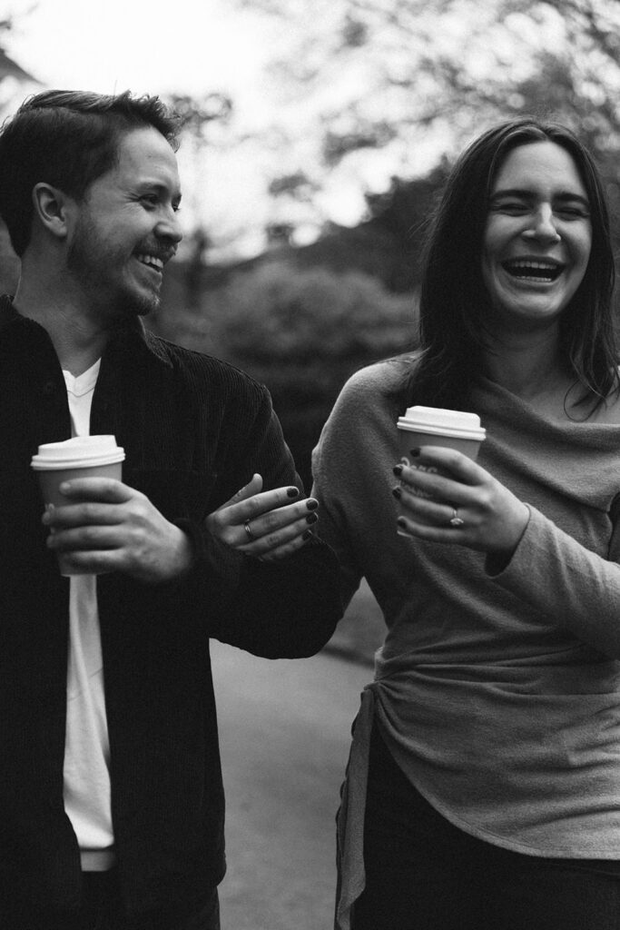 Peyton and Collin sharing a laugh while holding coffee cups in Virginia Highlands