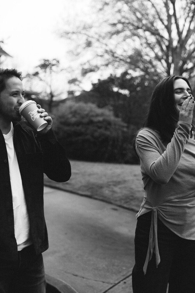 Fun engagement photo of the couple with coffee in hand in downtown Atlanta
