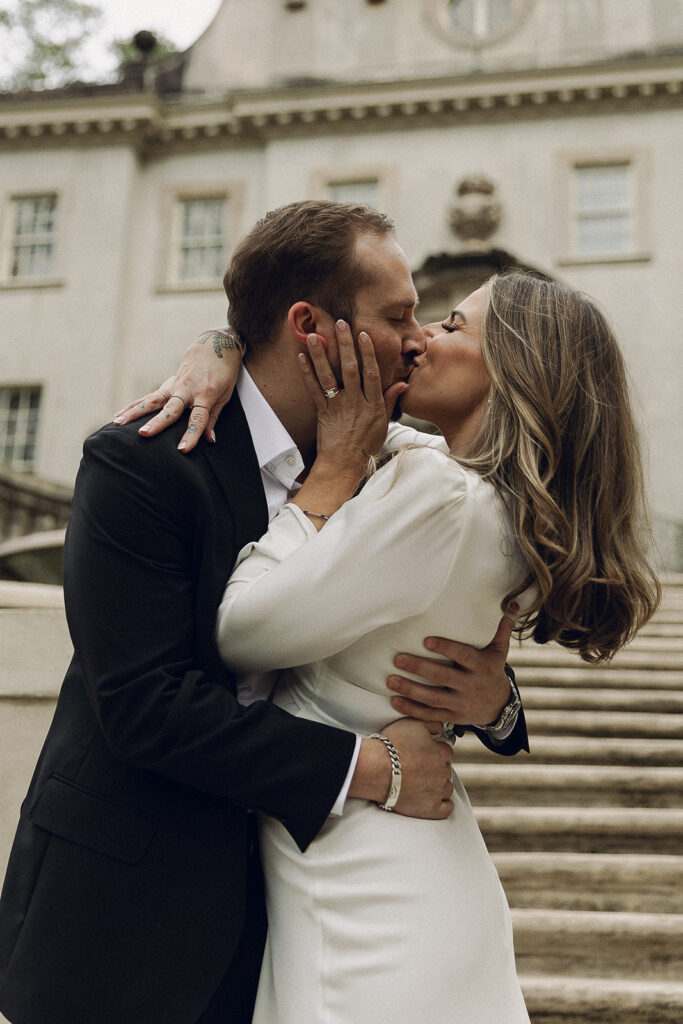 couple sharing kiss at swan house atlanta engagement session